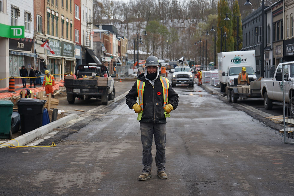 Construction worker standing in the middle of a busy construction site