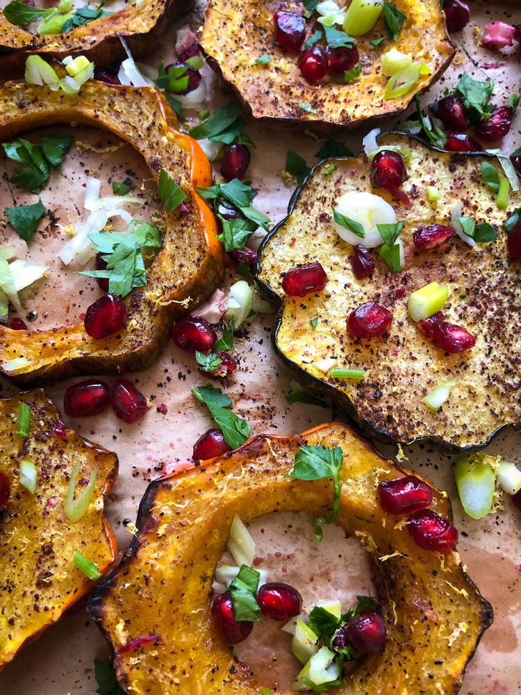 ROASTED ACORN SQUASH WITH POMEGRANATE, LEMON, & SUMAC