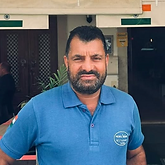 Johnny owner of Mehfi Indian Restaurant Tavira Portugal wearing blue polo shirt welcoming guests