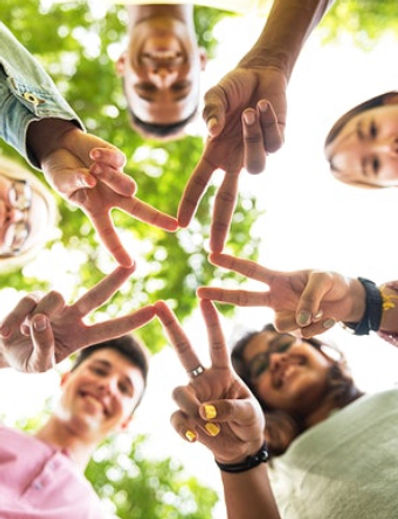 image of a group of people holding up their fingers to form the shape of a star 