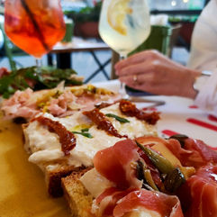 Selection of Pugliese-style open sandwiches with cured meats and burrata, served with cocktails at Vuliò. Photo by Damian Mexico.