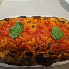 Roman-style pinsa with cherry tomatoes and basil at La Pratolina, Prati Rome. Photo by Cecille K.
