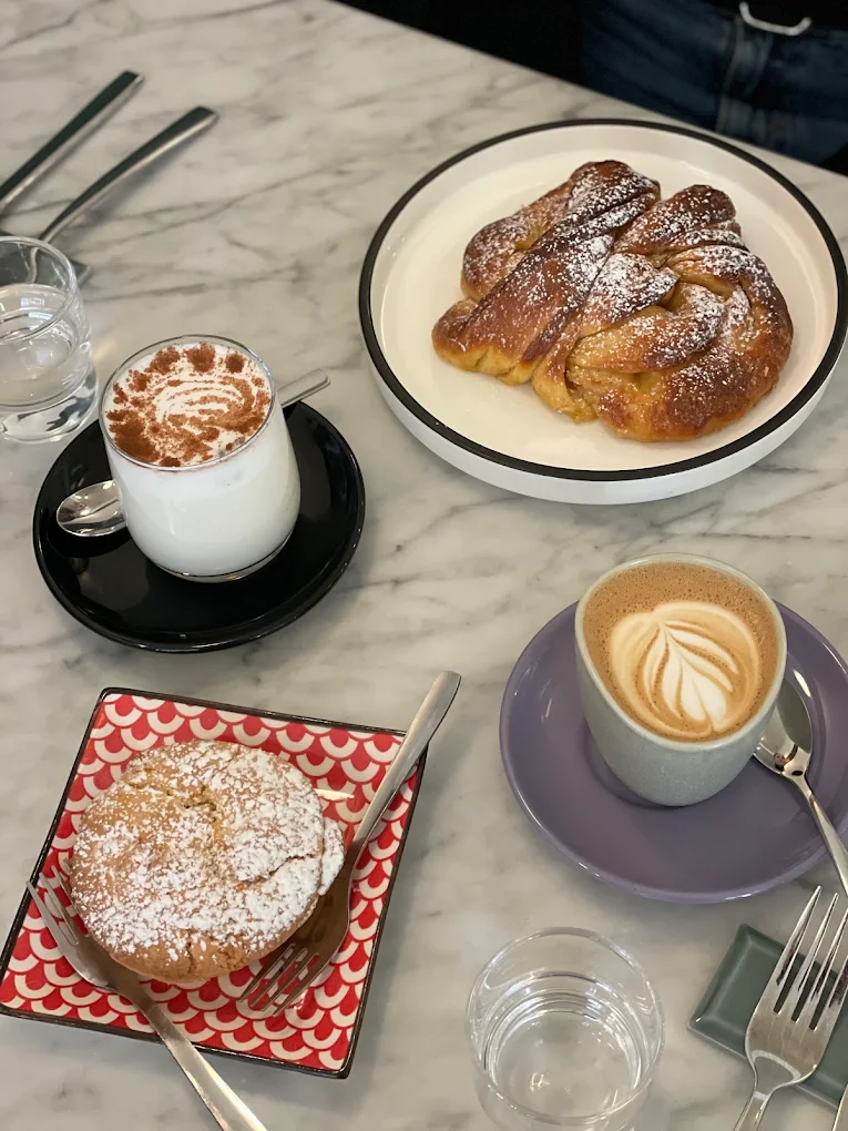 Breakfast spread with coffee, pastries, and brioche at MAE in Prati, Rome. Photo by Cicine Urbane.