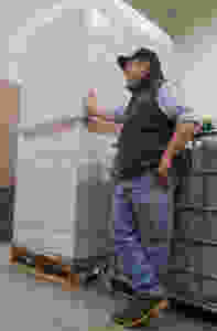 Jason with a pallet of glass wine bottles