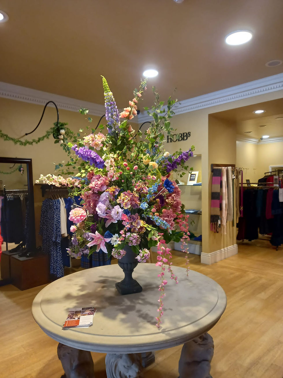 Large colourful floral arrangement welcoming visitors inside a Hobbs store