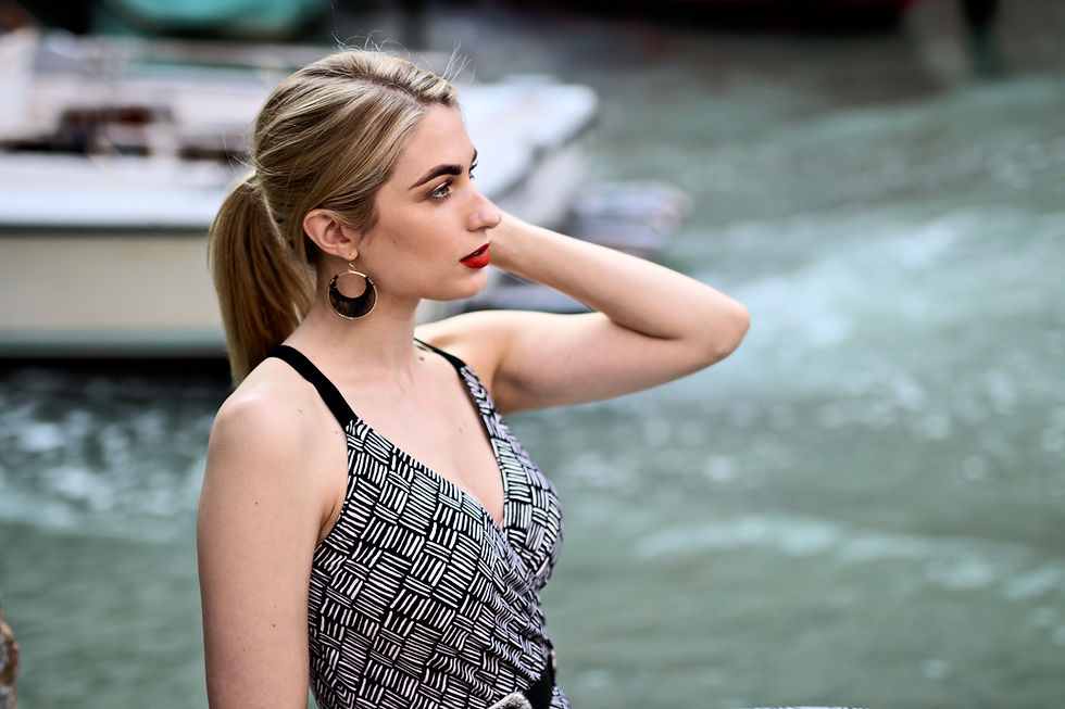 blonde female model next to a canal in Venice glamorous