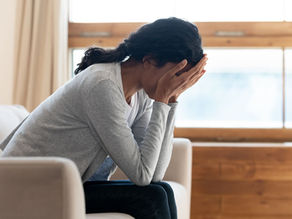 Hands over face grieving loss