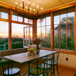 The informal dining room at The Terrace Oamaru captures the first morning light beautiful. Rimu Bi-fold windows feature in this very pretty room.