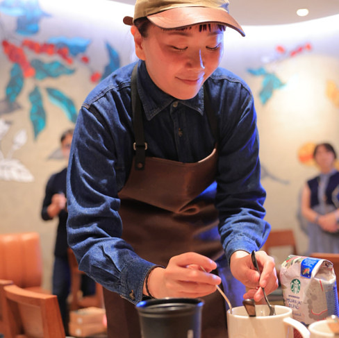 barista stirring coffee at starbucks