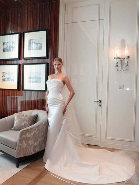 models showing white, floor-length wedding dresses by ASAVA in luxury hotel setting and romantic ambient lights