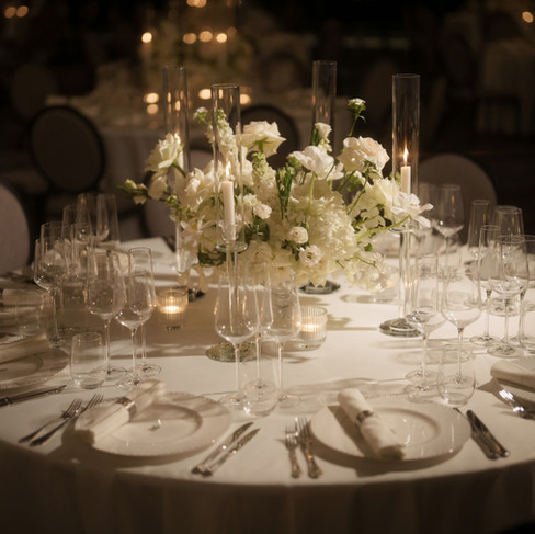 banquet setting for wedding showcase at The Ritz-Carlton Bangkok using white, understated them and luxury lighting