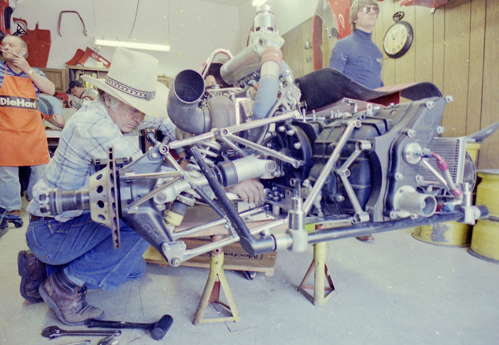 John Martin working on the engine of his race car in Gasoline Alley.