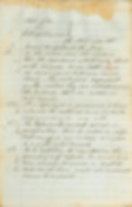 A stained piece of paper with writing in slanting cursive