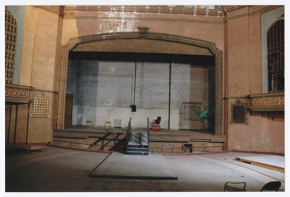 The Gillioz stage is shown mid renovation, with folding chairs and unfinished, peeling walls.