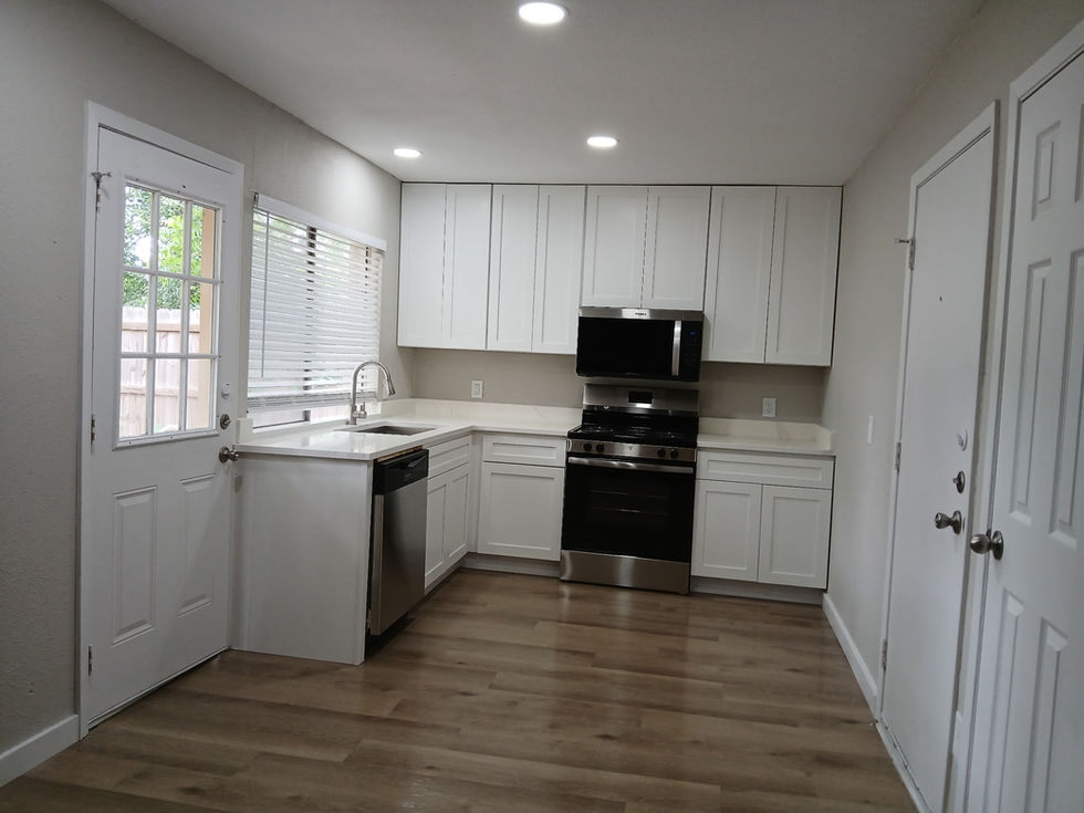 Finished kitchen with white Shaker cabinetry and stainless steel appliances
