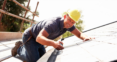 Man in hardhat measuring roof