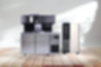 A black and silver automatic boba tea machine sits on a wooden floor, The screen displays setup options, and the overall design is modern and sleek.
