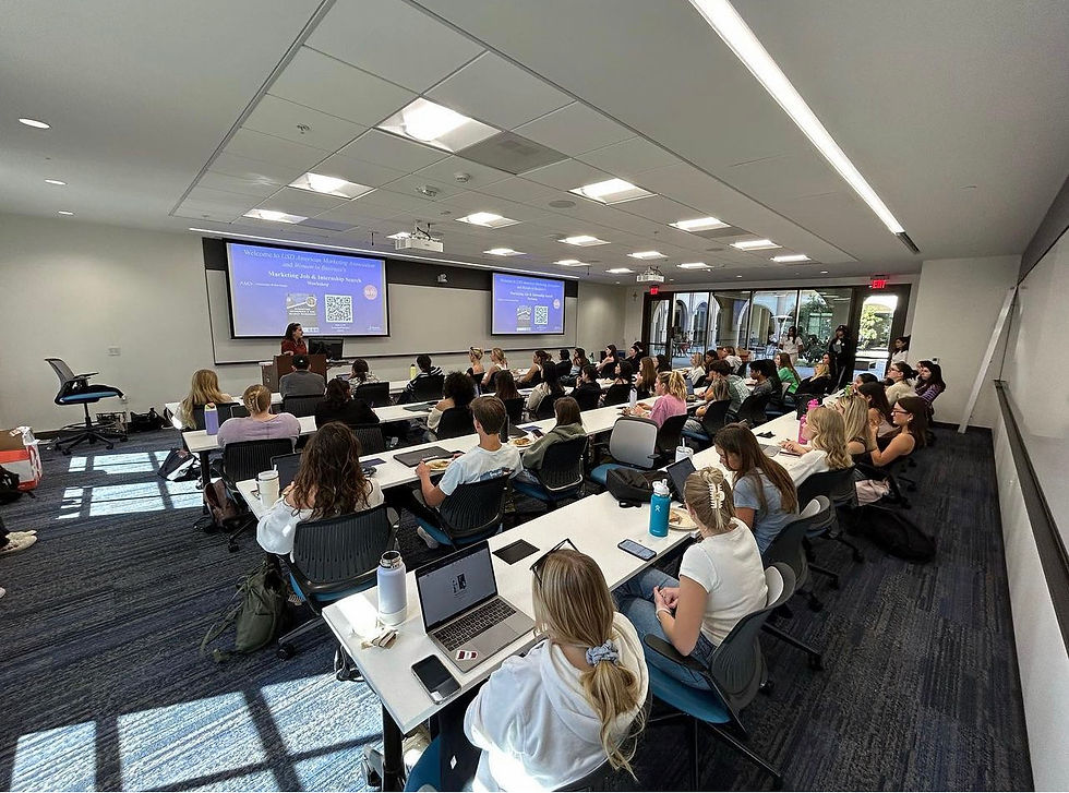 student in an event sitting at desks listening to speaker