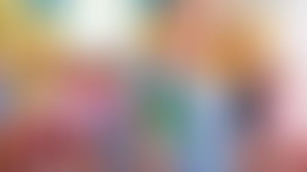 Smiling early years teacher with young children in a nursery classroom