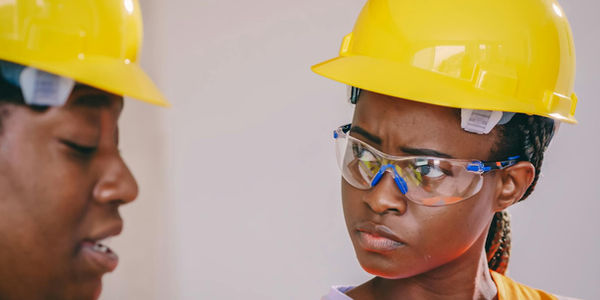 A group of construction workers in a safety meeting.