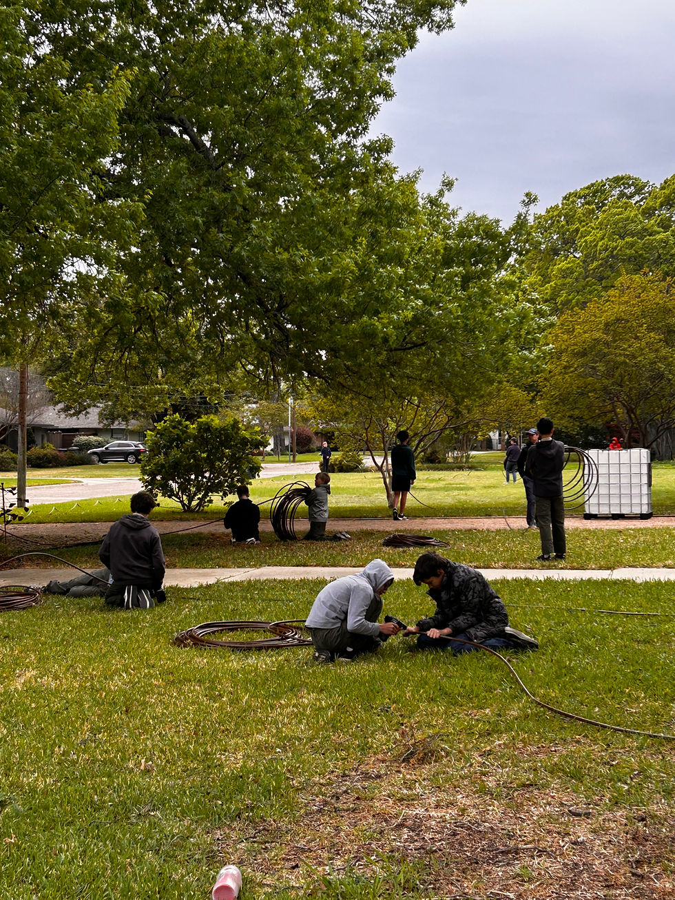 St. Mark's students help prep irrigation lines to be installed later at the Bachman Greenbelt.