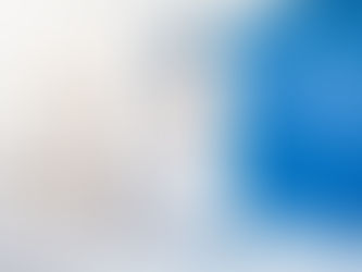 Painters applying white paint on blue interior wall.