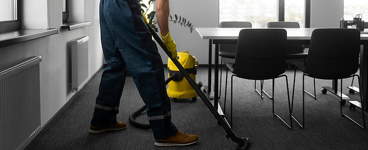 Worker using floor cleaning machine showing efficient junk removal and surface maintenance