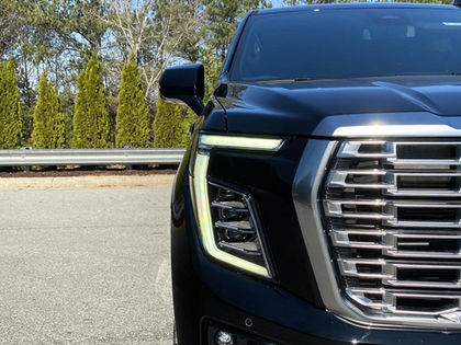Close-up of a black Yukon Denali's front.