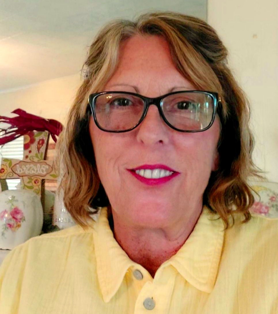 Kimberli Matthews, a board-certified Psychiatric Mental Health Nurse Practitioner, wearing a yellow polo shirt.