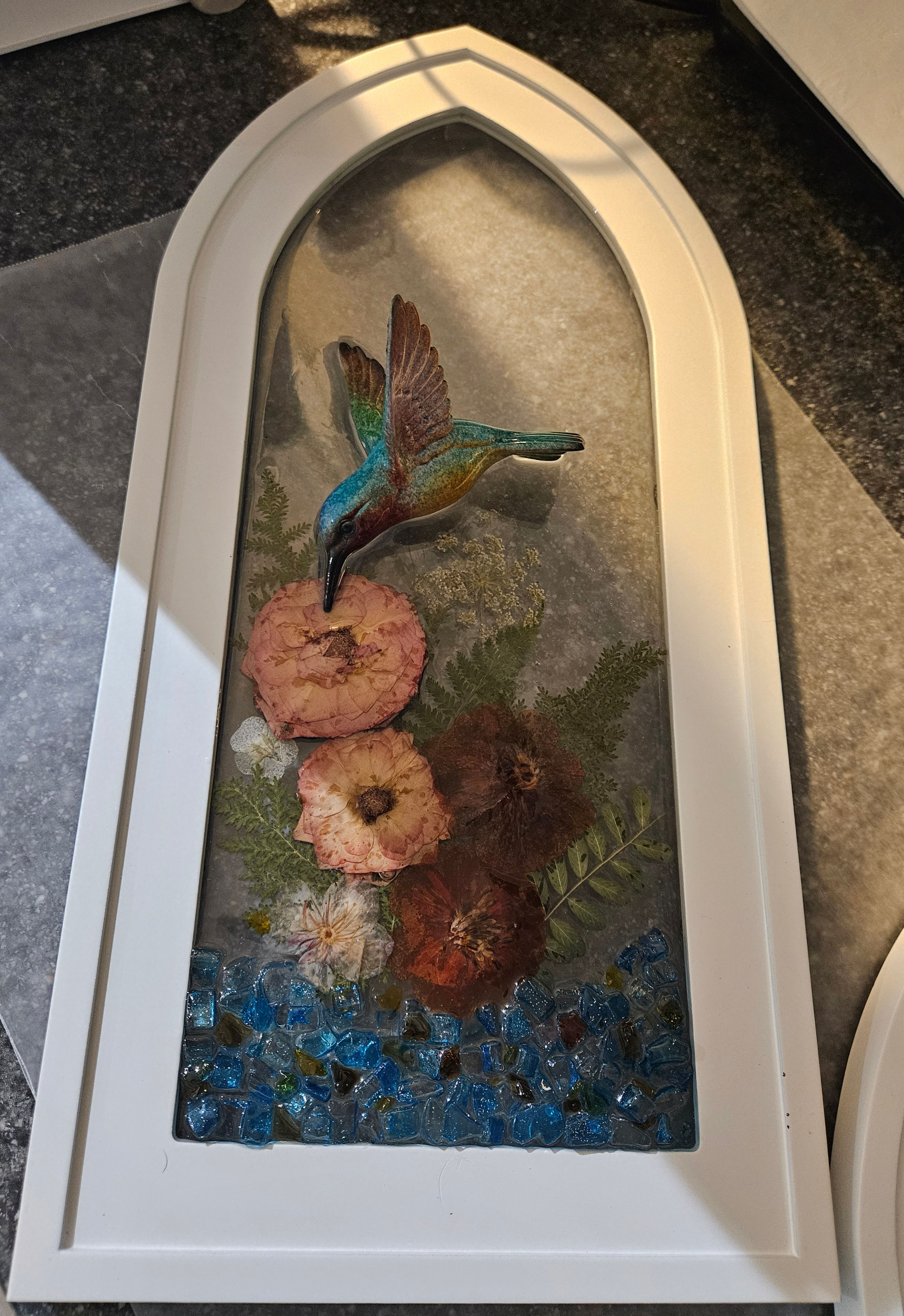 #831 Large arched frame w/hummingbird and blue florals