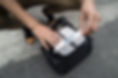 Person organizing records in a black bag