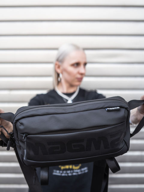 Woman displays black SOLID BLAZE X-BAG