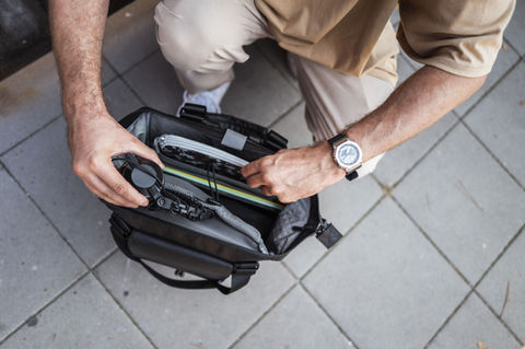 Person packing Solid Blaze Tote Pack 85