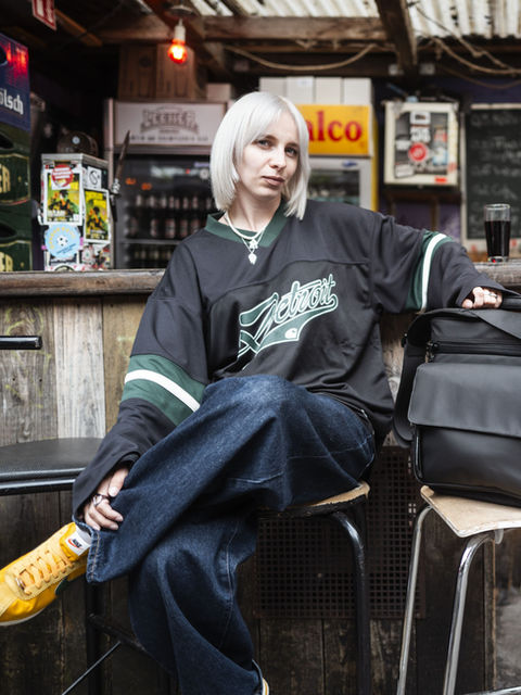 Woman in jersey with Solid Blaze Vinyl- Bag