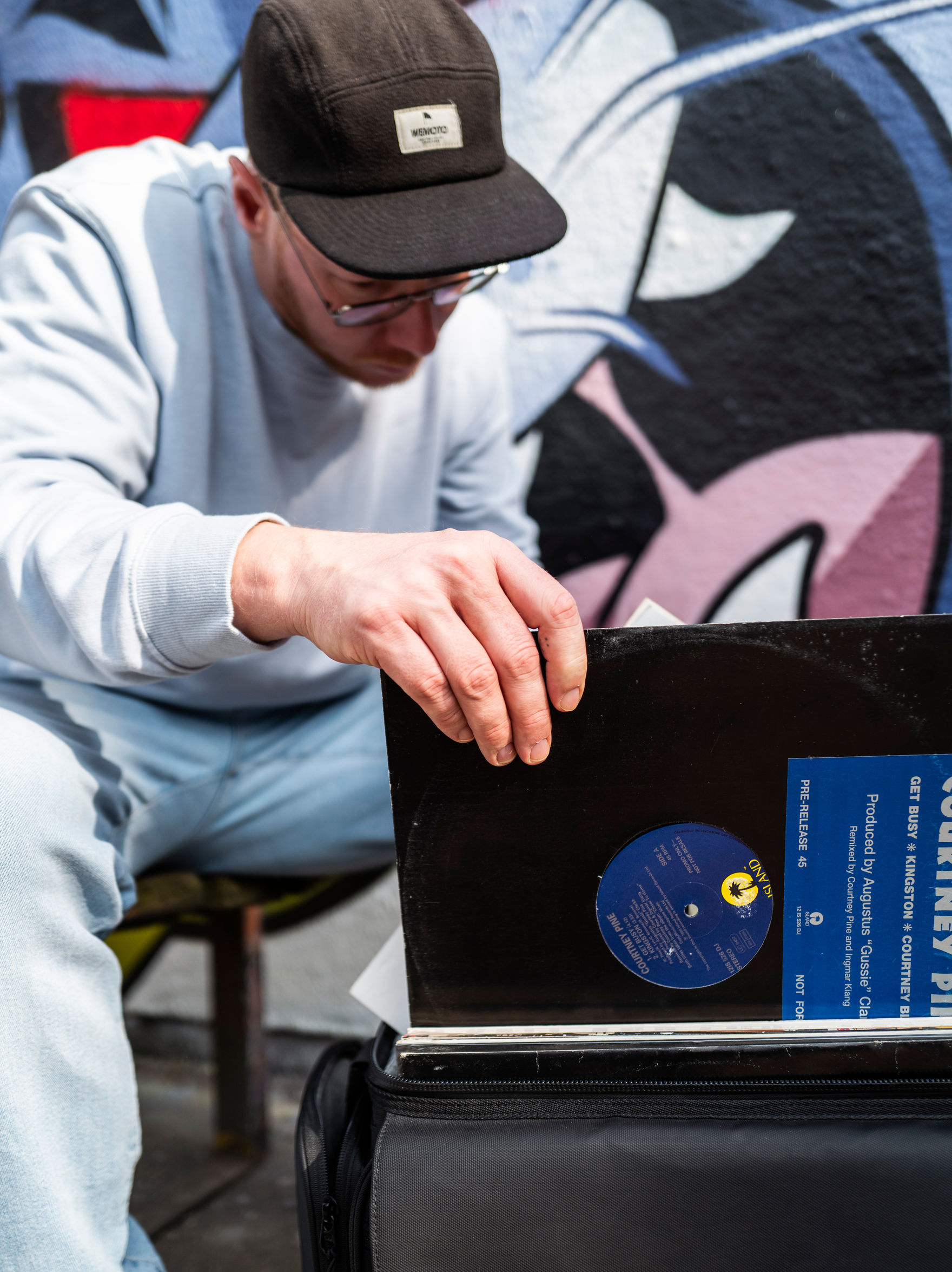 Man selects vinyl record from Solid Blaze Vinyl Trolley
