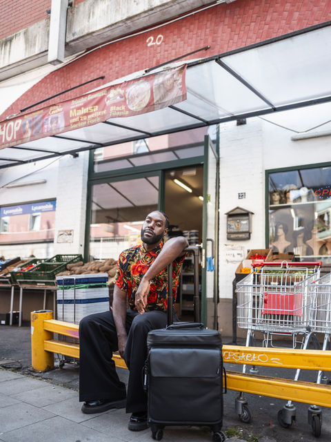 Man sits by store with Solid Blaze Cabin Trolley