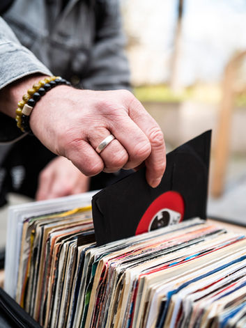 Person selects vinyl record from crate