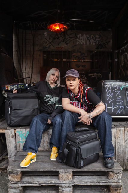 Two musicians pose with Solid Blaze Vinyl Trolley