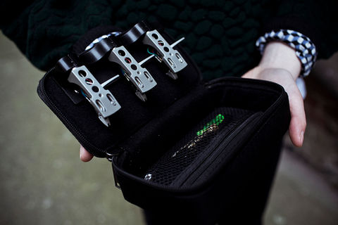 Person holding black case with three headshell cartridges