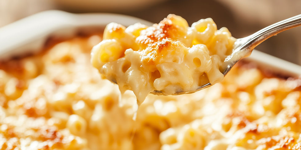 Close-up of creamy, golden-brown baked macaroni and cheese on a spoon, with a blurred casserole background, evoking warmth and comfort.