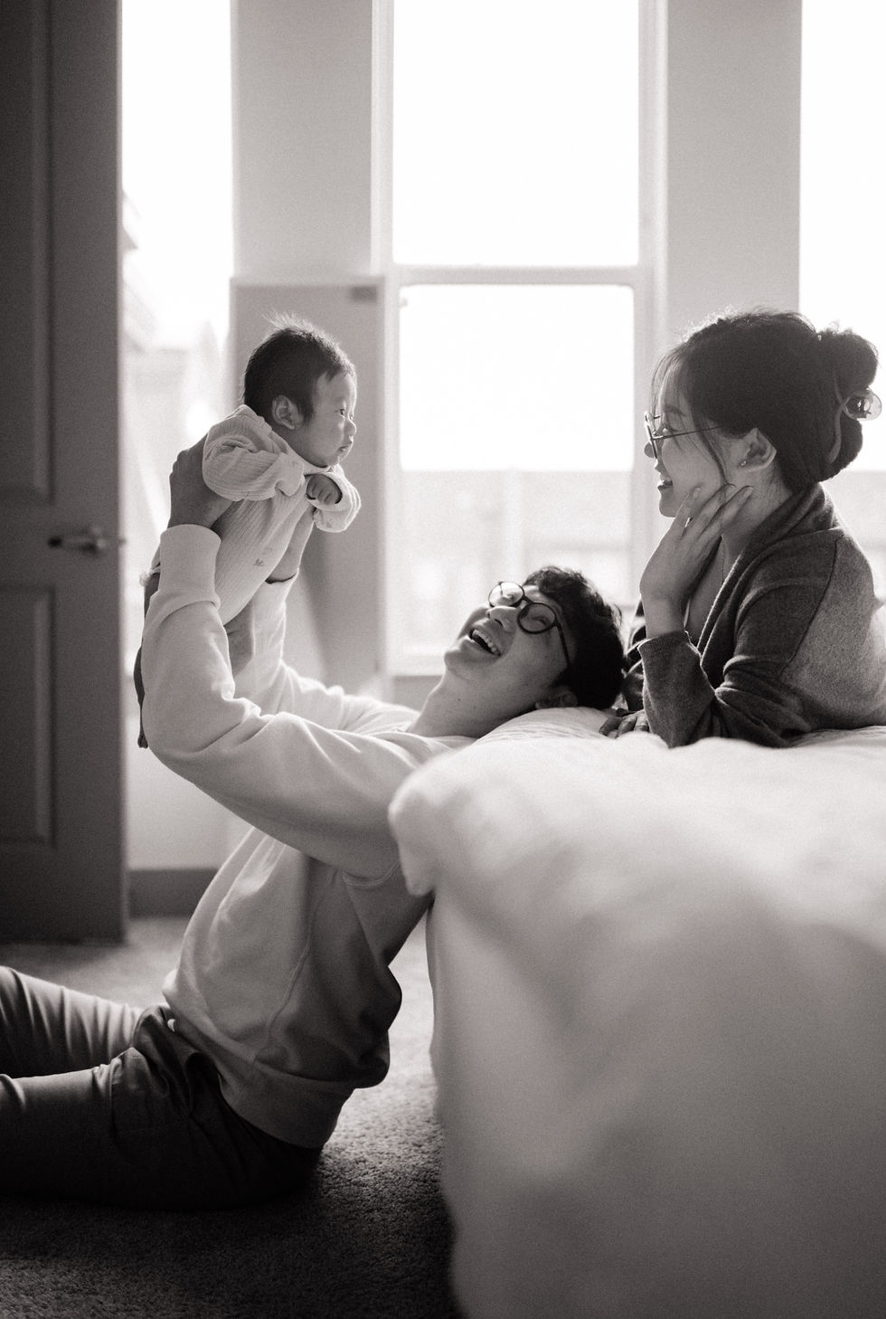 parents lift up baby at home| Dallas inhome newborn lifestyle photography session