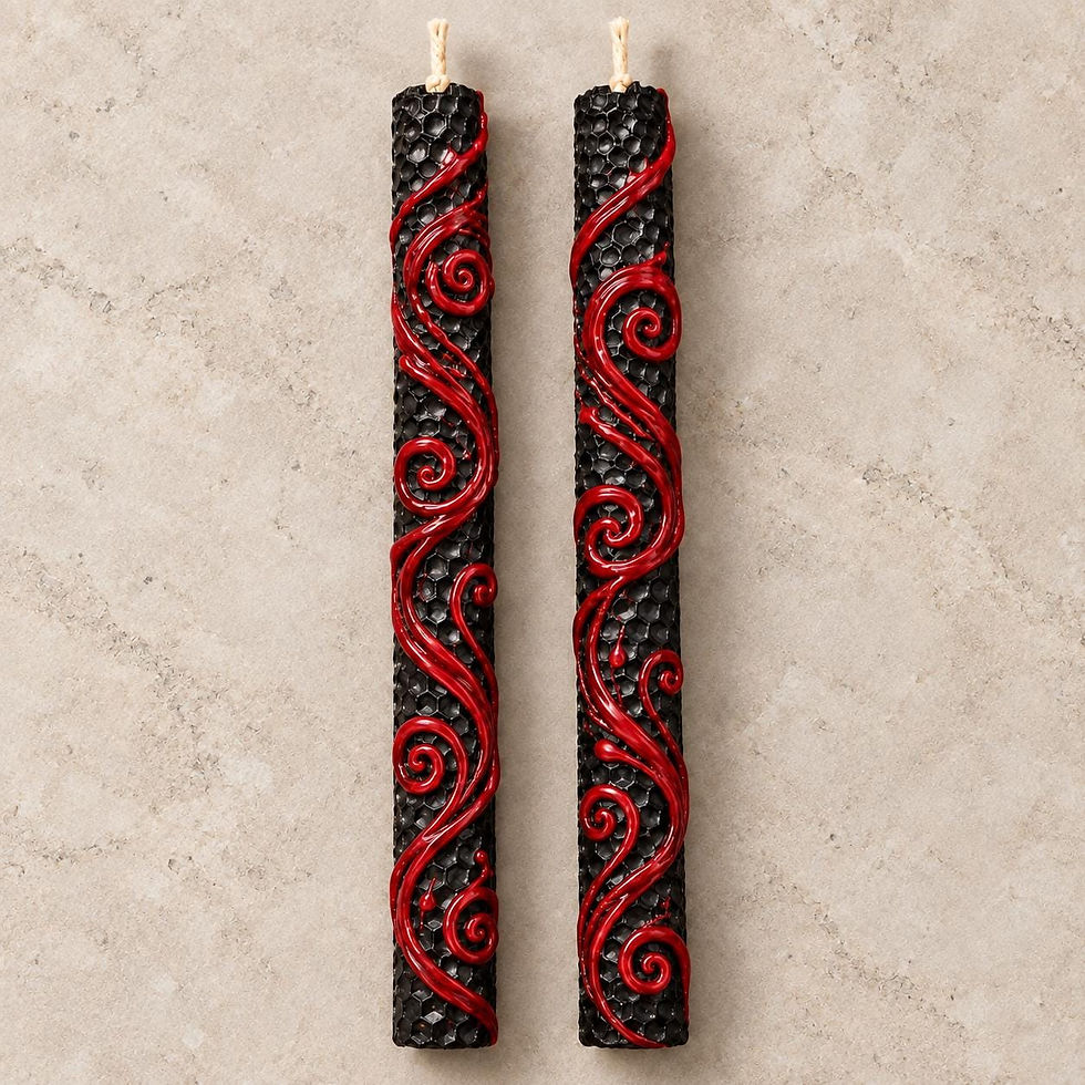 Two tall, cylindrical black candles with a textured honeycomb pattern. Each candle features a raised, glossy red decorative swirl design that winds vertically along the length of the wax. A single light-coloured wick protrudes from the top.