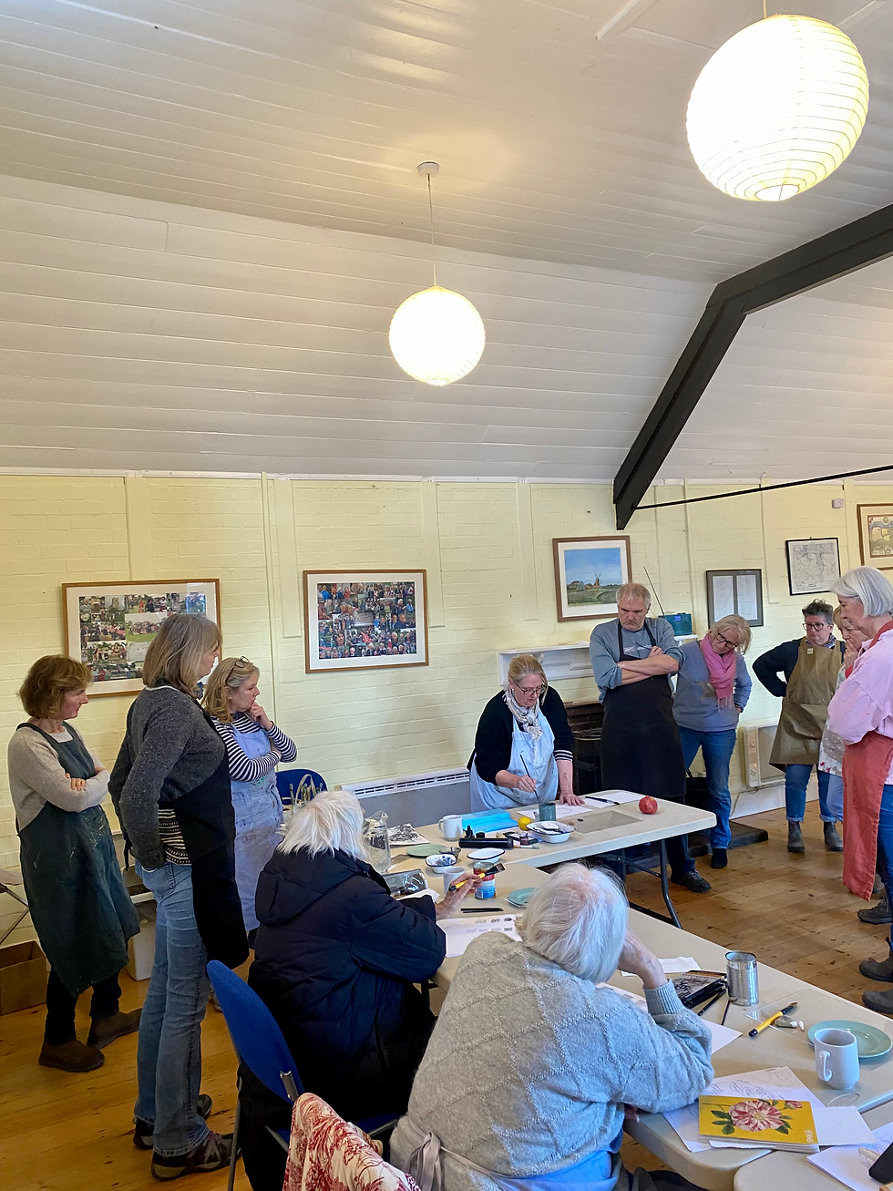 Mary Blue demonstrating how to set up a painting while guests watch during an adult painting workshop at Reef Make & Do in North Norfolk.