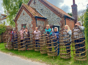 A whole class of makers with their willow obelisks.