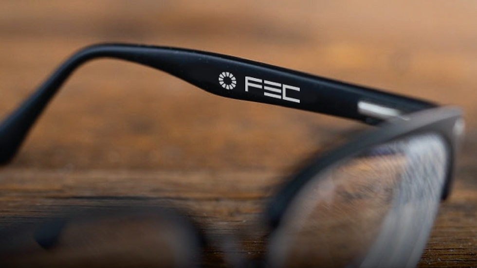 close view of FEC eyewear brand on black eyeglasses