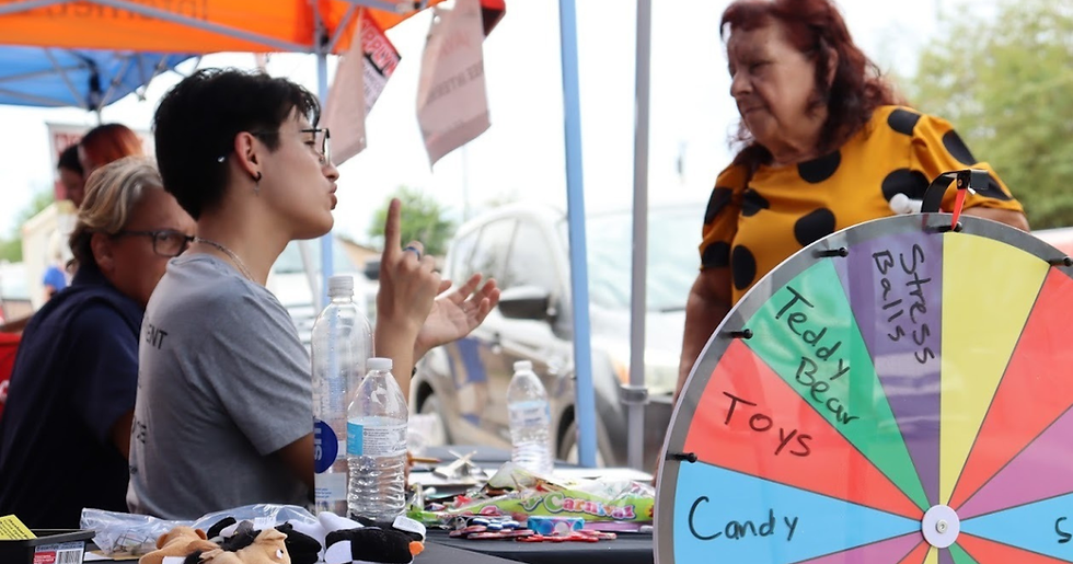 Oscar tabling for RAZE at a community event in San Luis in 2023.