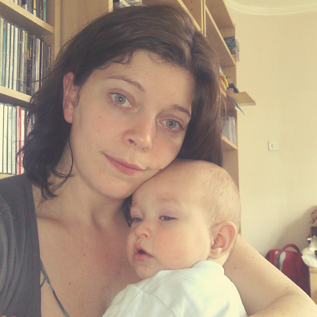 Sophie Shaw hypnotherapist and Reiki Master holding her baby son