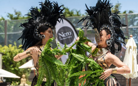 Women dancing together at Marbella beach club day party