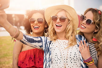 A group of women laughing and enjoying the sun together during a Marbella hen party