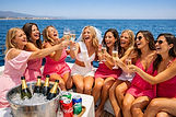 Hen party group toasting with prosecco on a boat off the Marbella coast, Costa del Sol